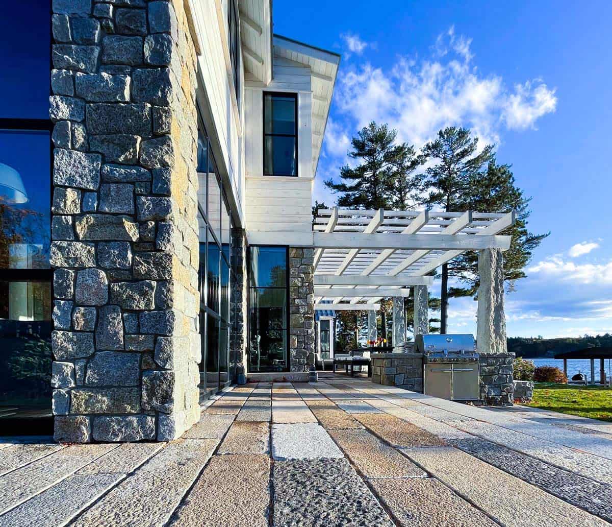 Stone column and pergola with outdoor grill and lake view