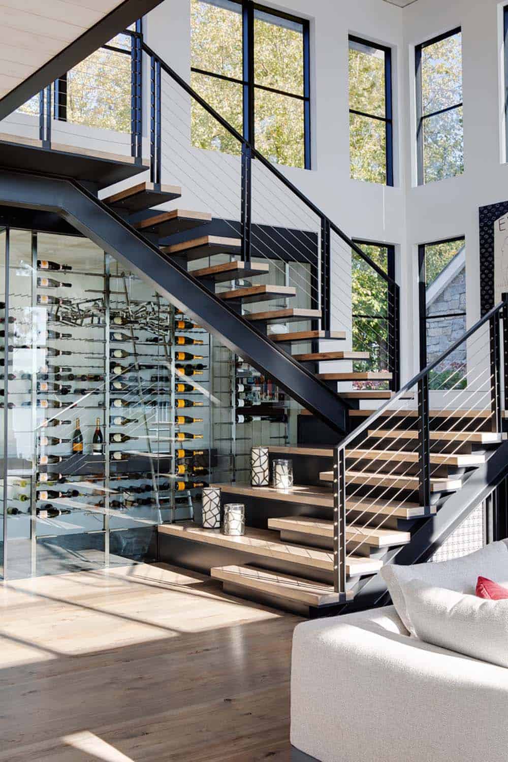 Floating staircase with glass-enclosed wine cellar underneath