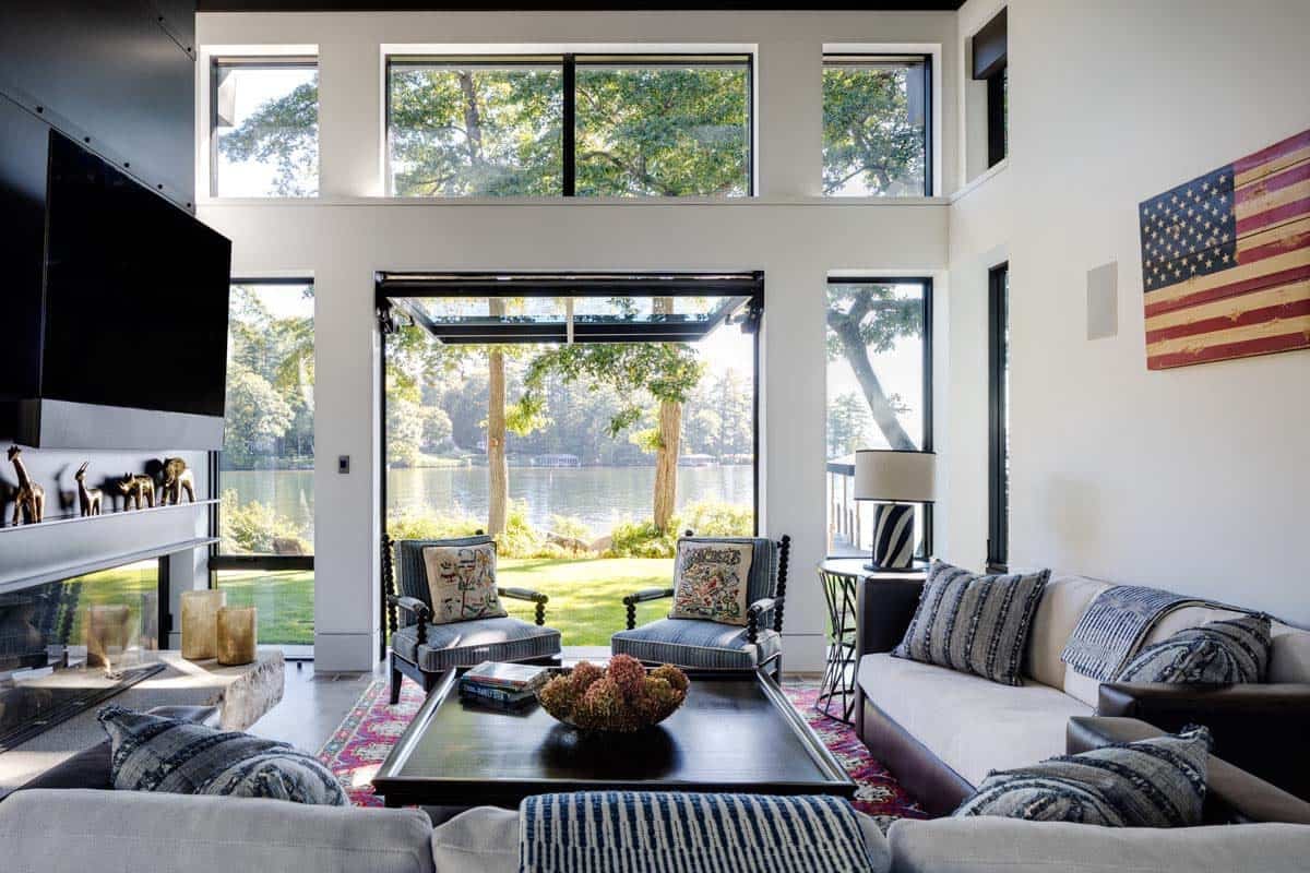 Living room with striped armchairs and open doors to lake