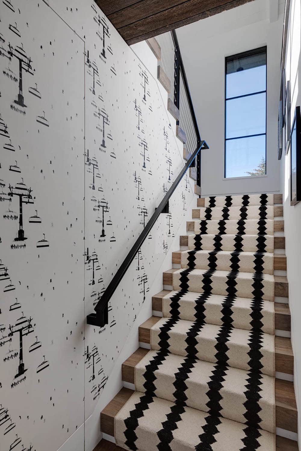 Staircase with ski lift wallpaper and striped stair runner