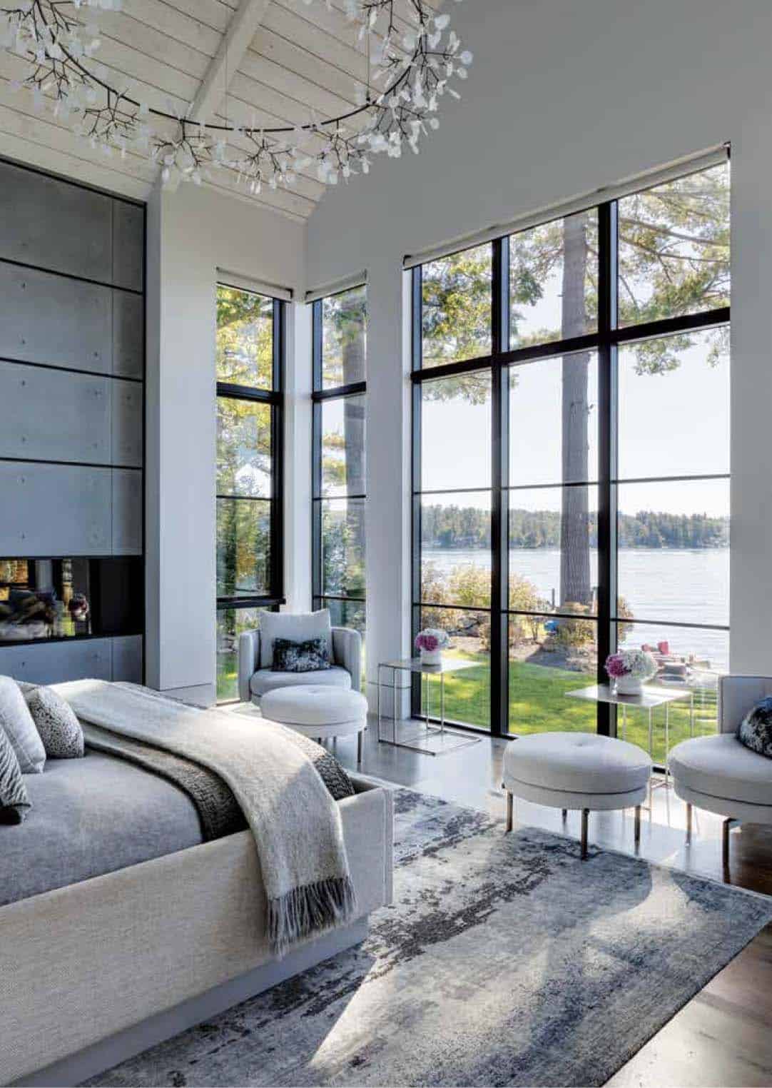 Bedroom with floor-to-ceiling windows overlooking the lake