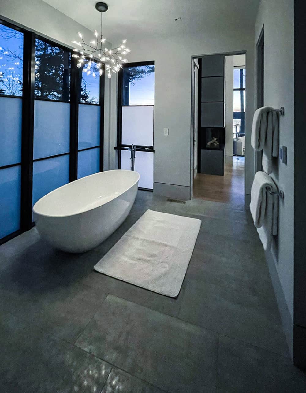Bathroom with freestanding tub and floor-to-ceiling frosted windows