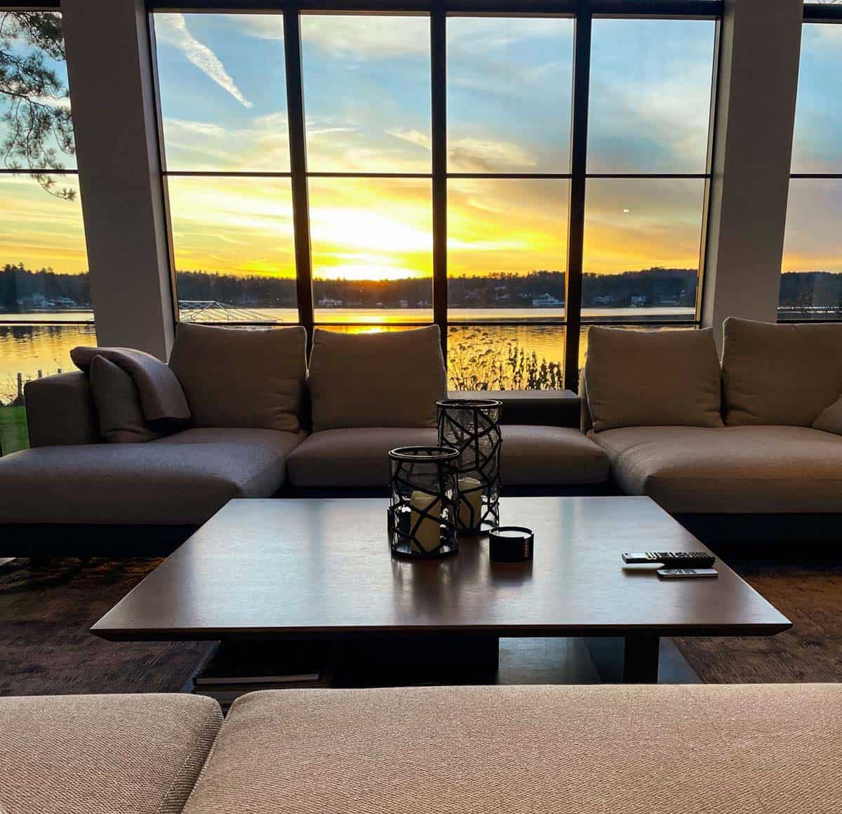 Living room sectional facing sunset view over the lake