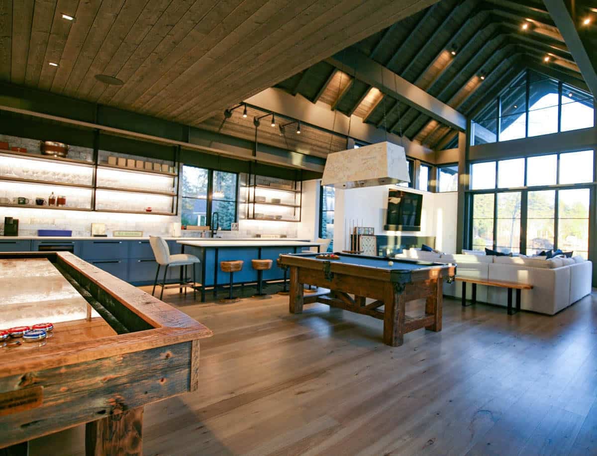 Vaulted game room with pool table, shuffleboard, and lake-view seating