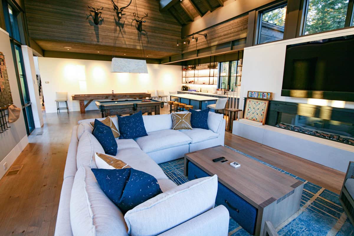 Game room lounge with mounted antlers and wall-mounted television