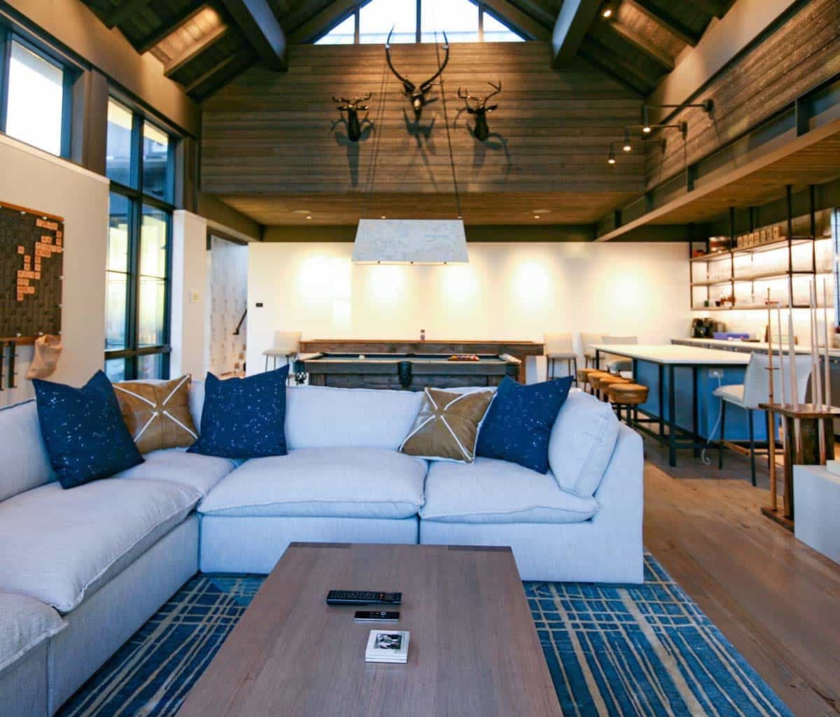 Game room lounge with mounted antlers and wall-mounted television