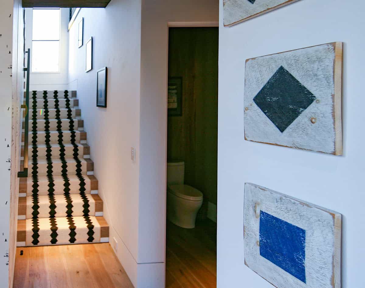 Staircase with ski lift wallpaper and striped stair runner