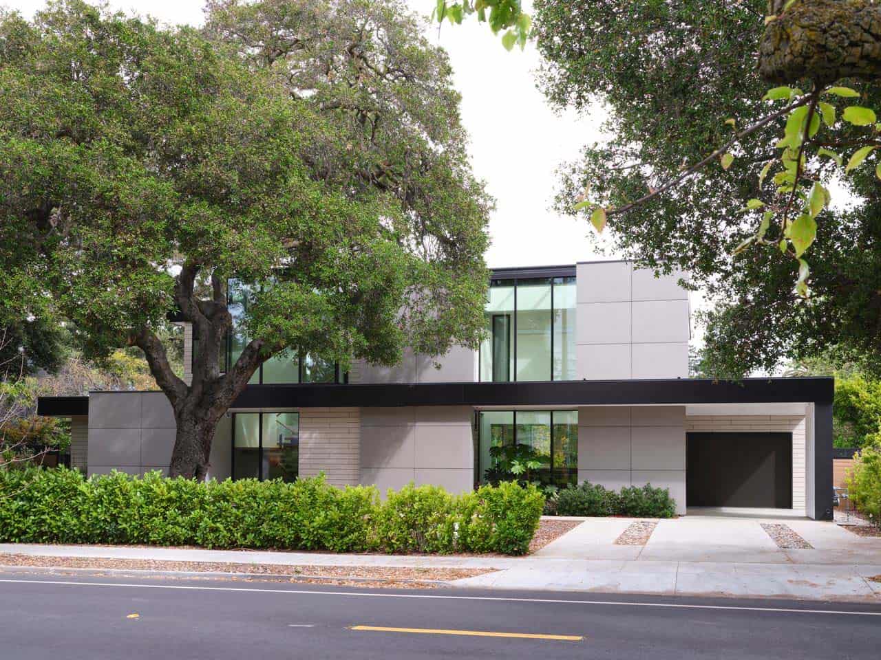 Modern two-story home with light gray siding shaded by a mature oak tree, Palo Alto