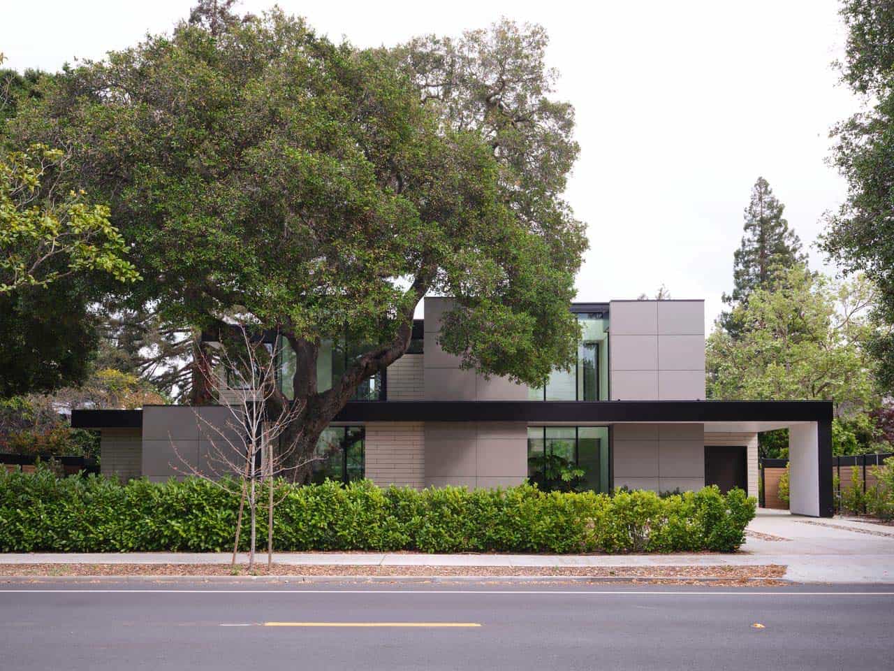 Street view of the Lantern House exterior framed by a large protected oak tree