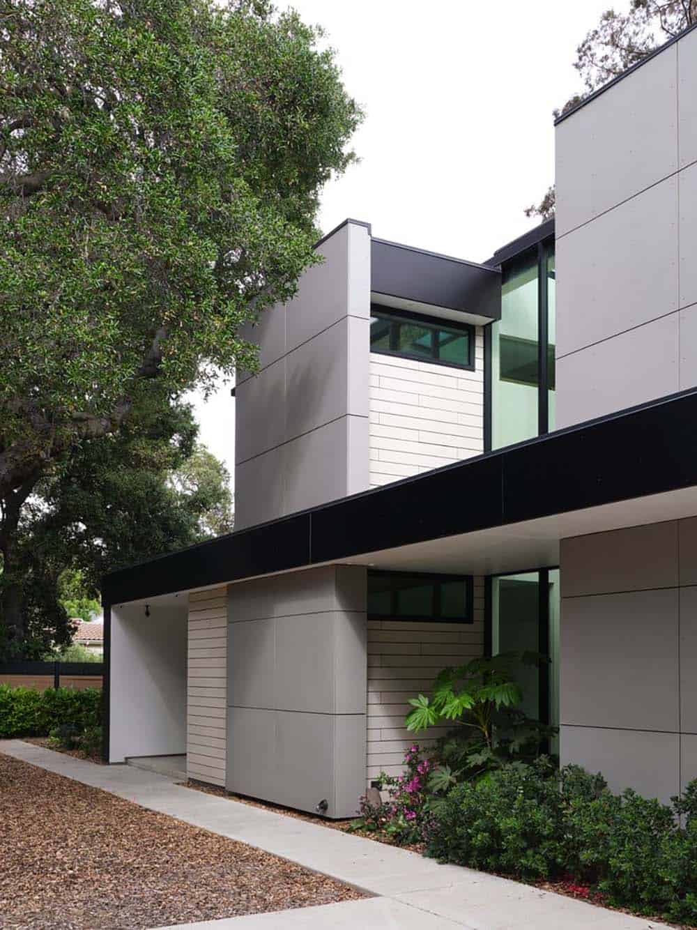Exterior corner detail showing black steel canopy and siding textures