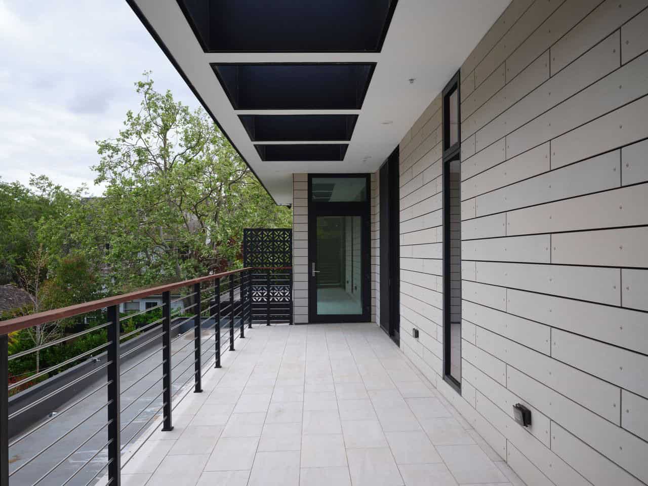 Rooftop deck with skylights and cementitious siding along the bedroom wing