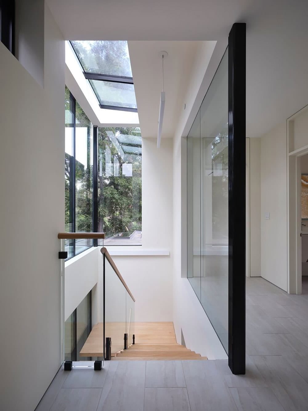 View down the stairwell lantern showing operable skylight and wood stairs