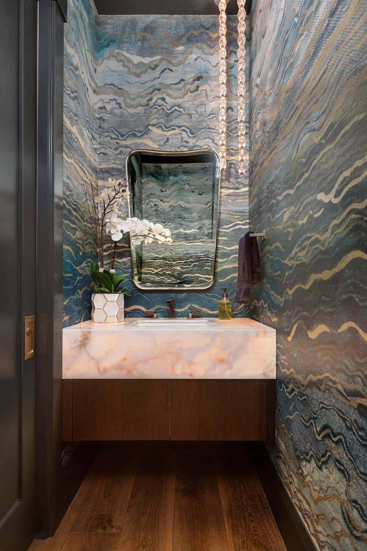 Powder room floating onyx vanity beneath marbled blue wave wallpaper