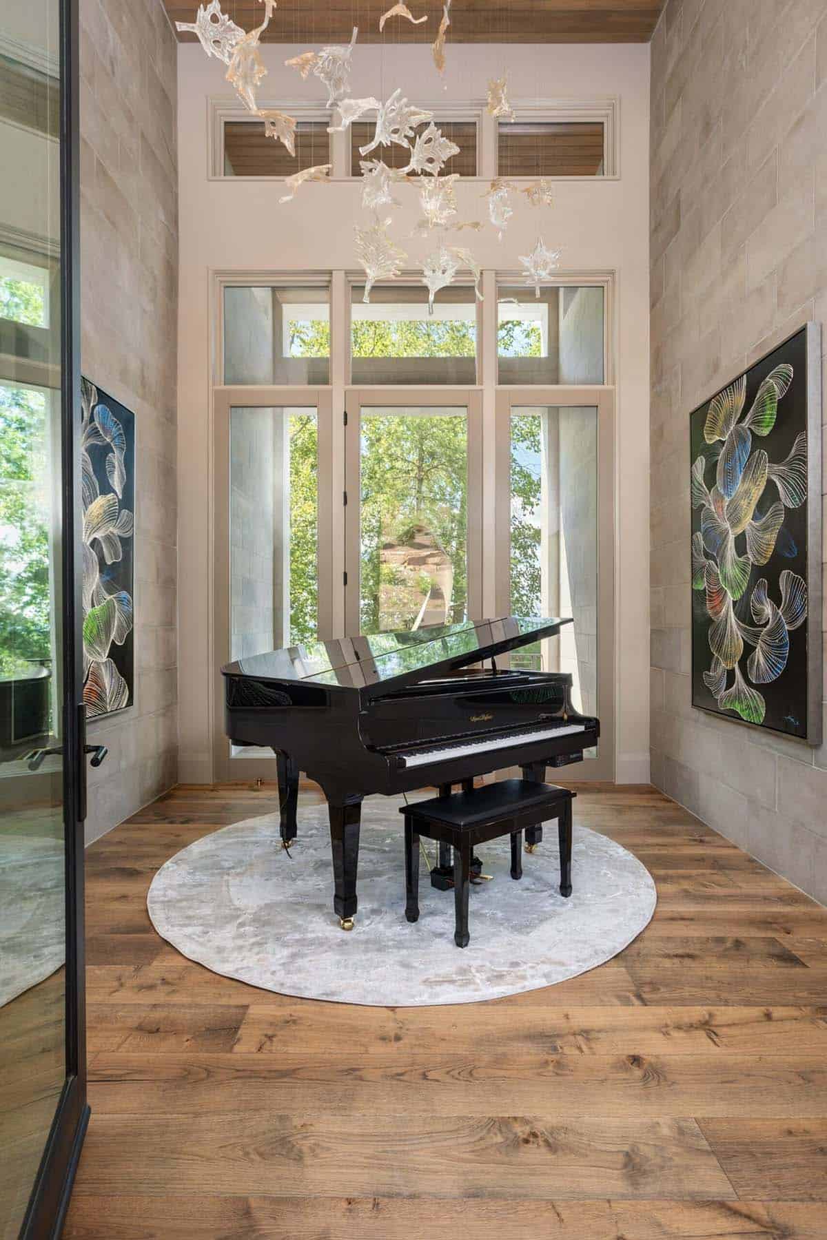 Music nook with grand piano framed by tall arched glass doors