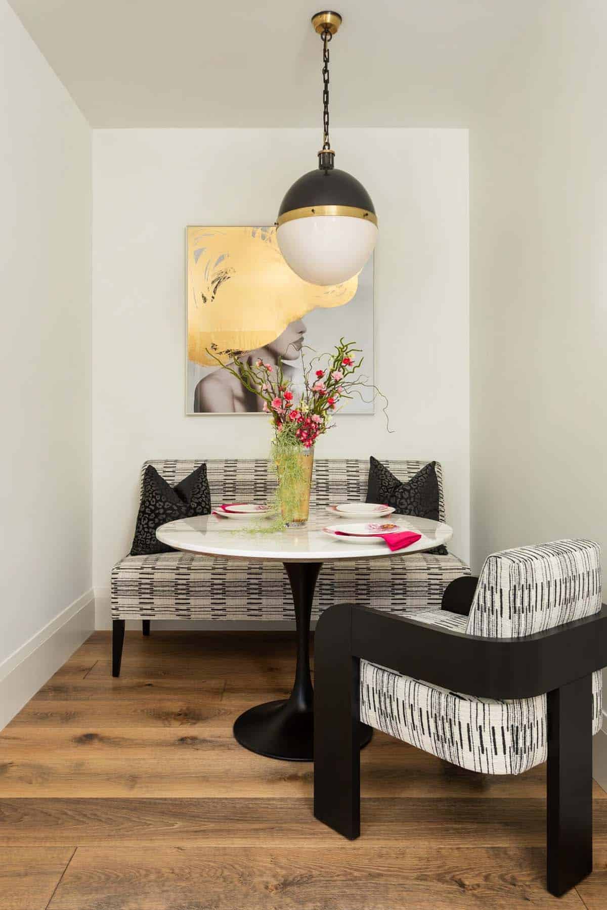 Breakfast nook with striped banquette and black globe pendant light