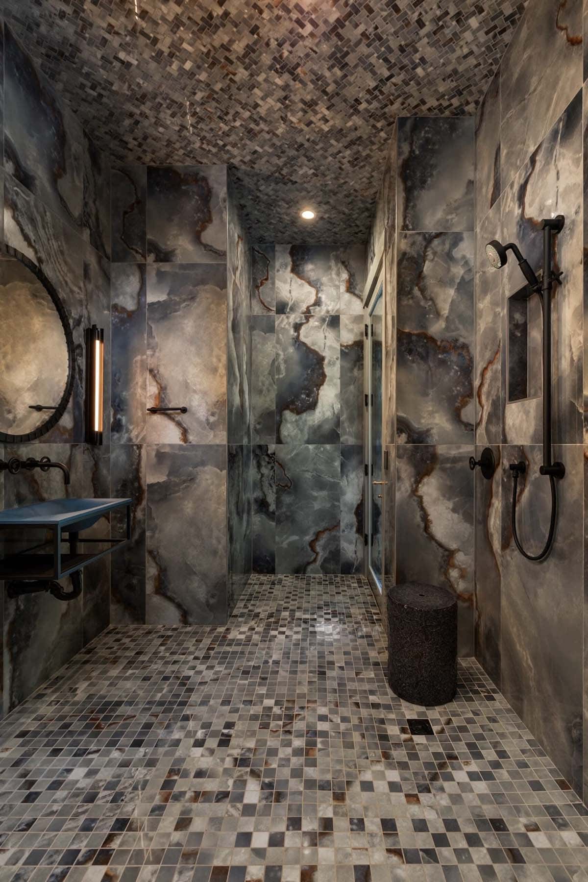 Onyx clad steam shower with mosaic floor and matching tiled ceiling