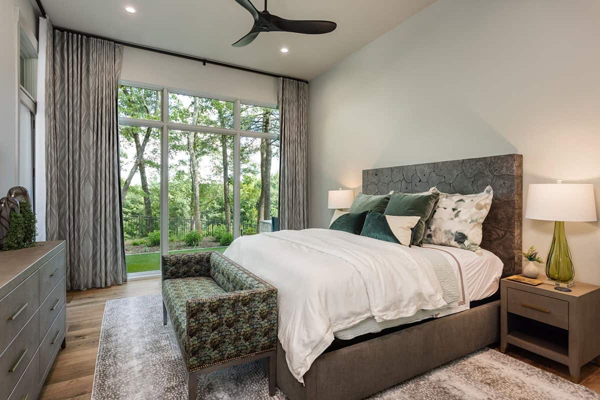 Guest bedroom with stone patterned headboard and patterned green accent bench