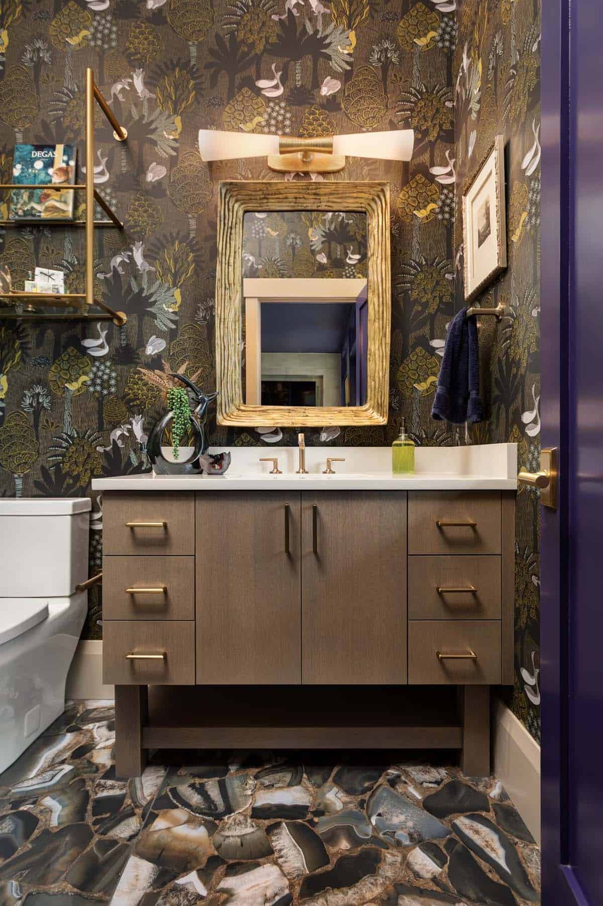 Powder room vanity with gold branch mirror and botanical print wallpaper