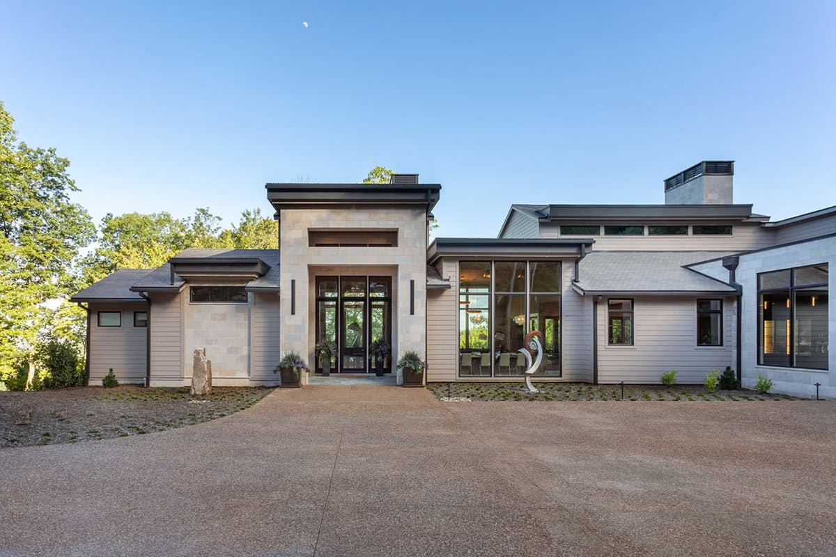 Front elevation with stacked stone entry tower and floor to ceiling windows
