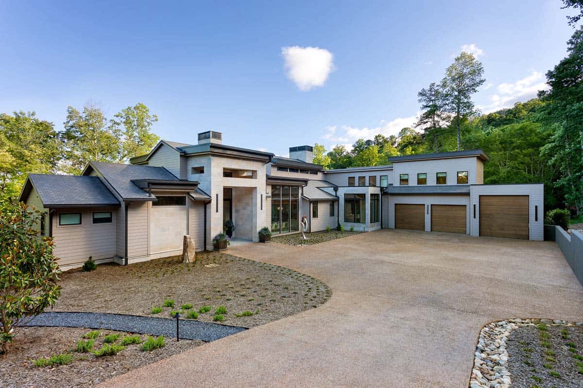 Exterior view of home with three car garage and curved driveway