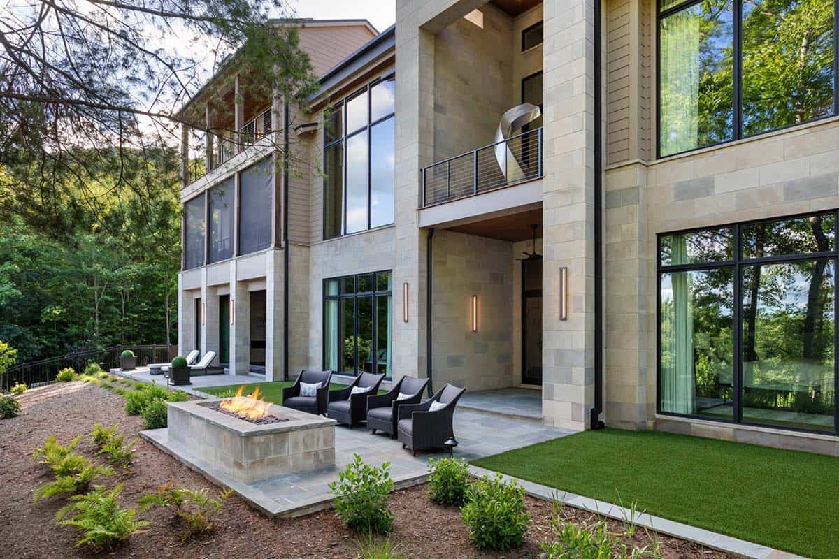 Rear patio with fire pit, woven chairs, and stacked balcony views