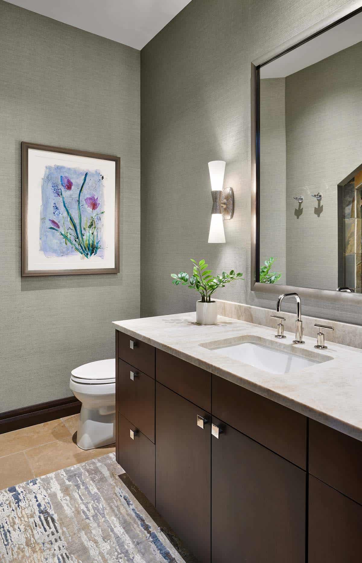 Powder room with dark wood vanity, textured gray wallpaper, and floral artwork
