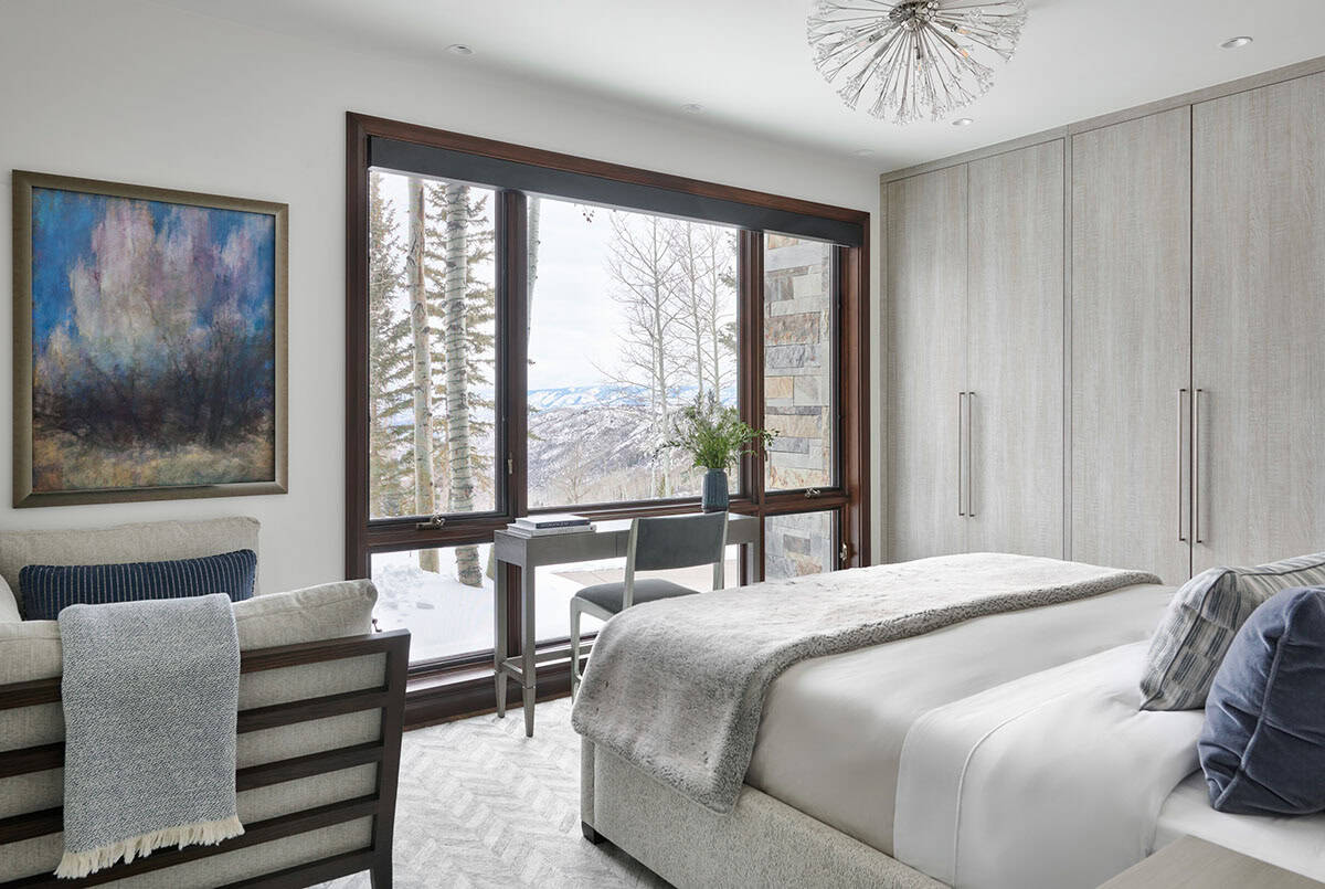 Bedroom with wardrobe, window desk nook, and mountain forest view