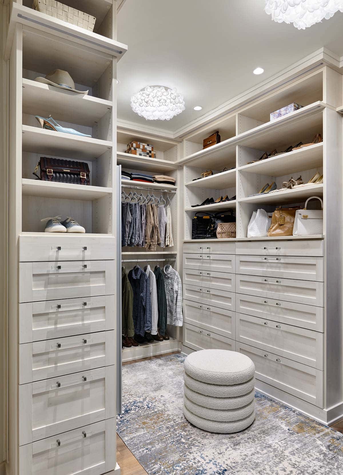 Walk-in closet with open shelving for shoes, bags, and folded clothing