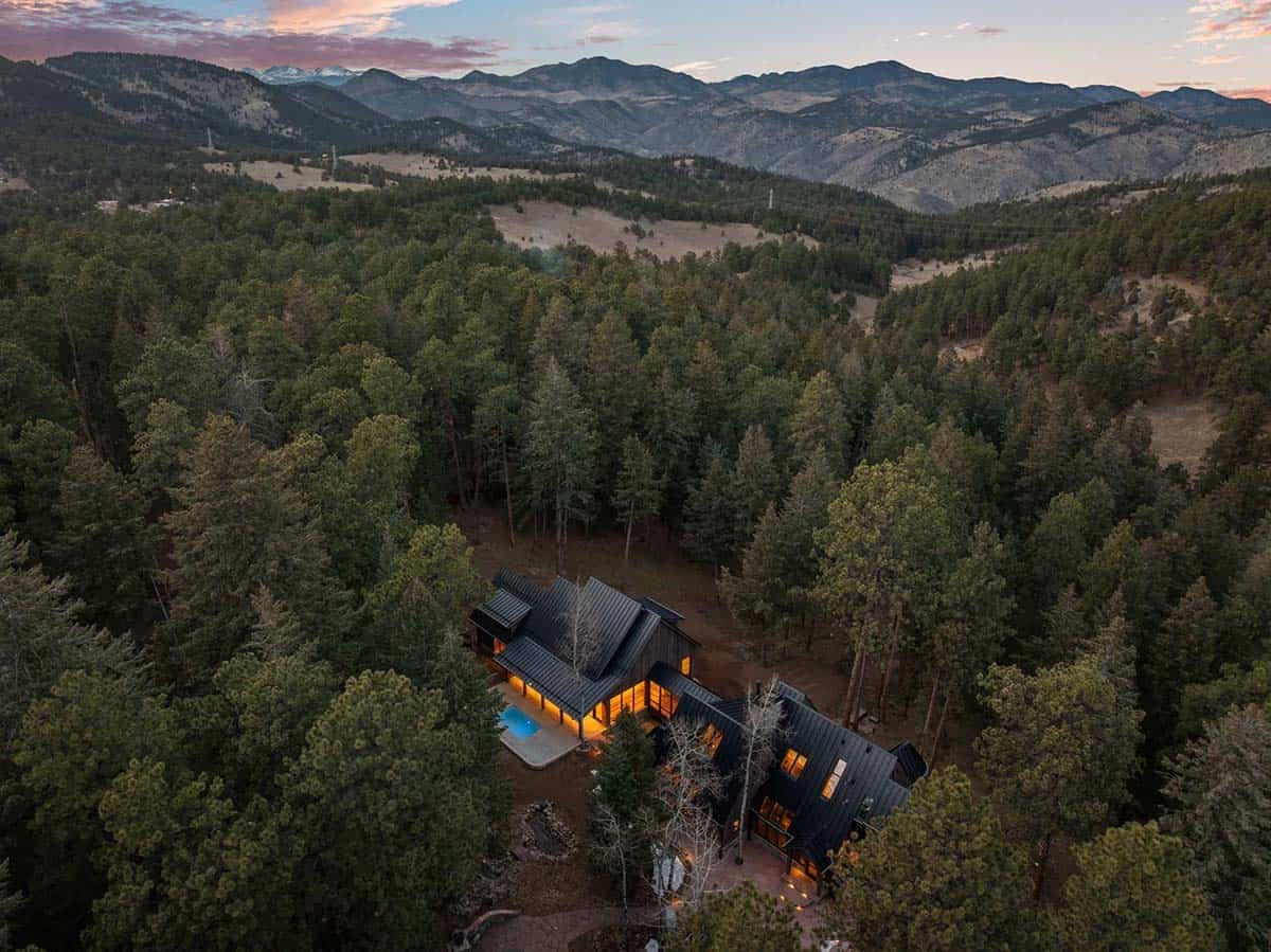 Aerial view shows the home nestled deep in pine forest