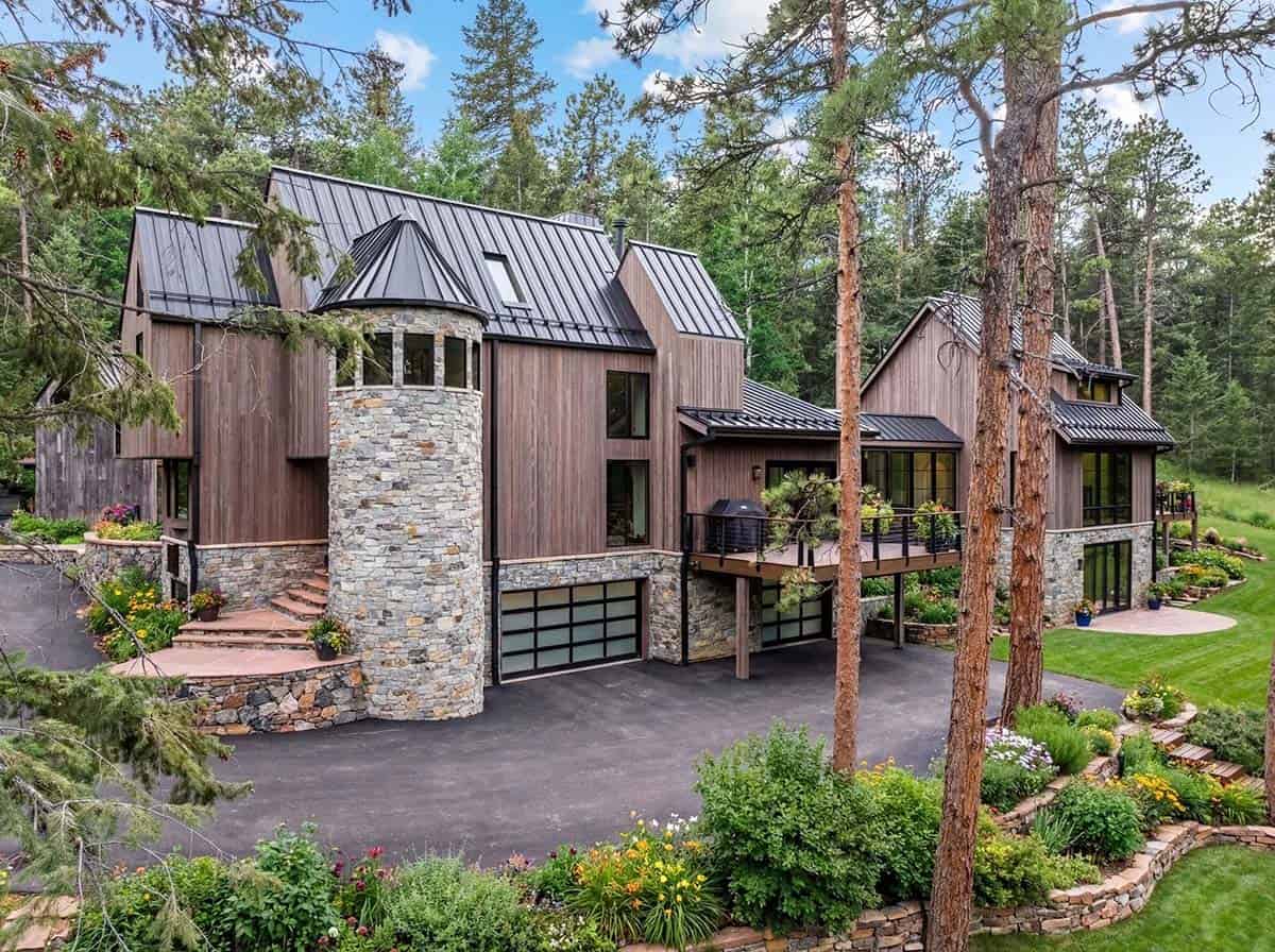 Stone turret and wood siding anchor the mountain home exterior