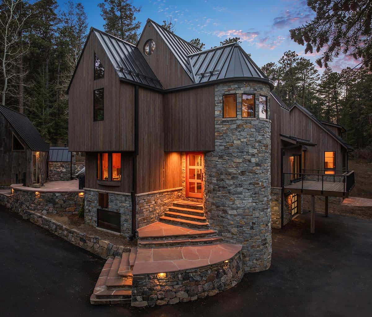 Curved stone tower rises beside the timber-clad mountain facade