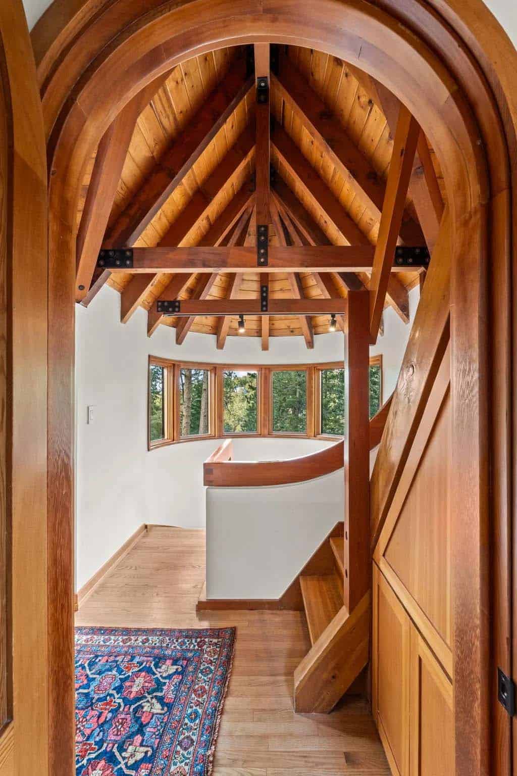 Arched doorway frames a turret window seat and stairs