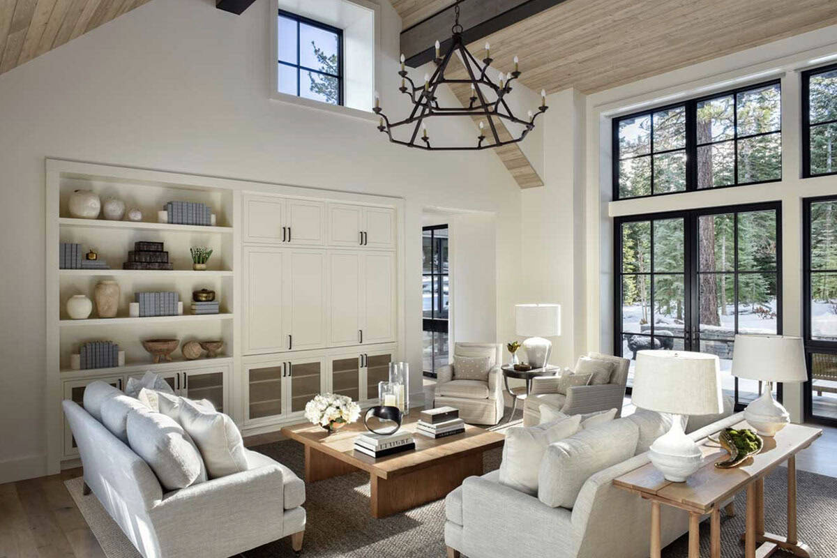 Vaulted living room with wood-clad ceiling, built-in shelving, and large black-framed windows