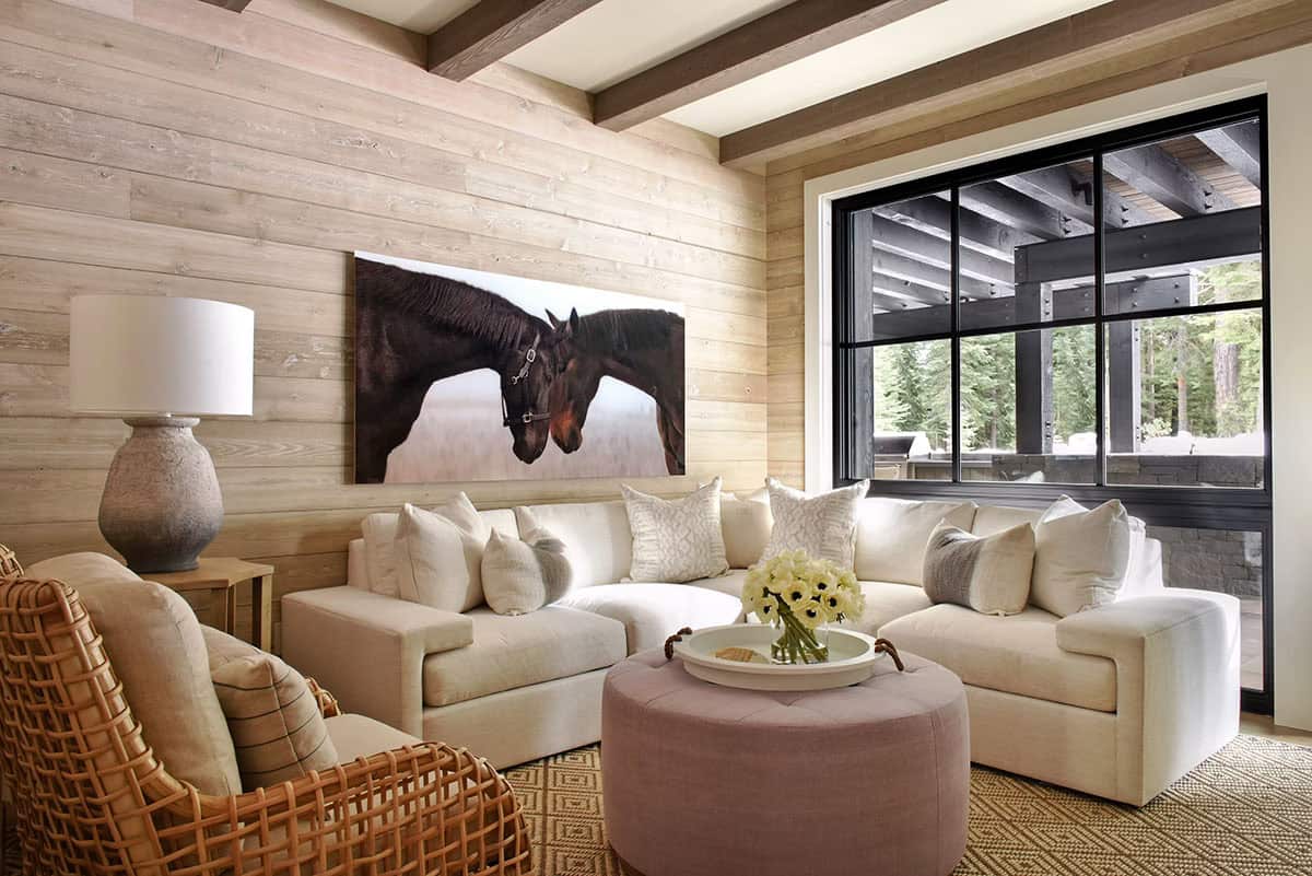 Cozy den with shiplap walls, horse artwork, and cream sectional sofa