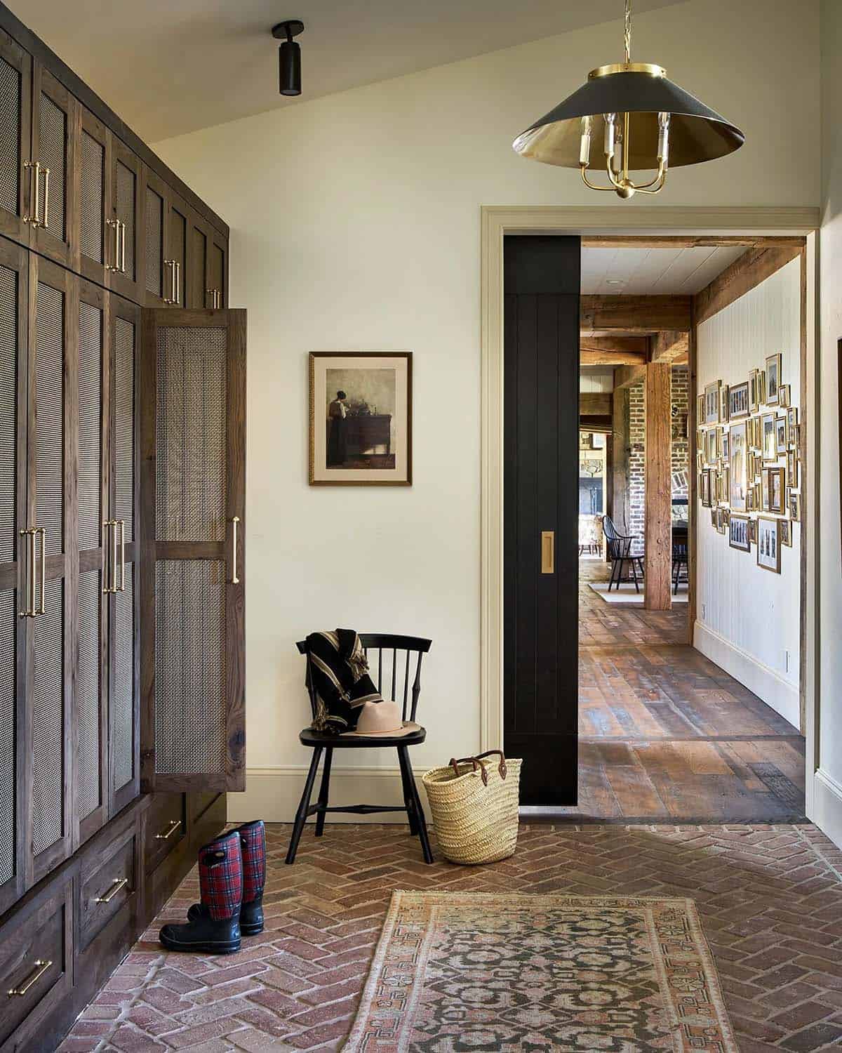 Mudroom with mesh-front cabinetry and herringbone brick floor
