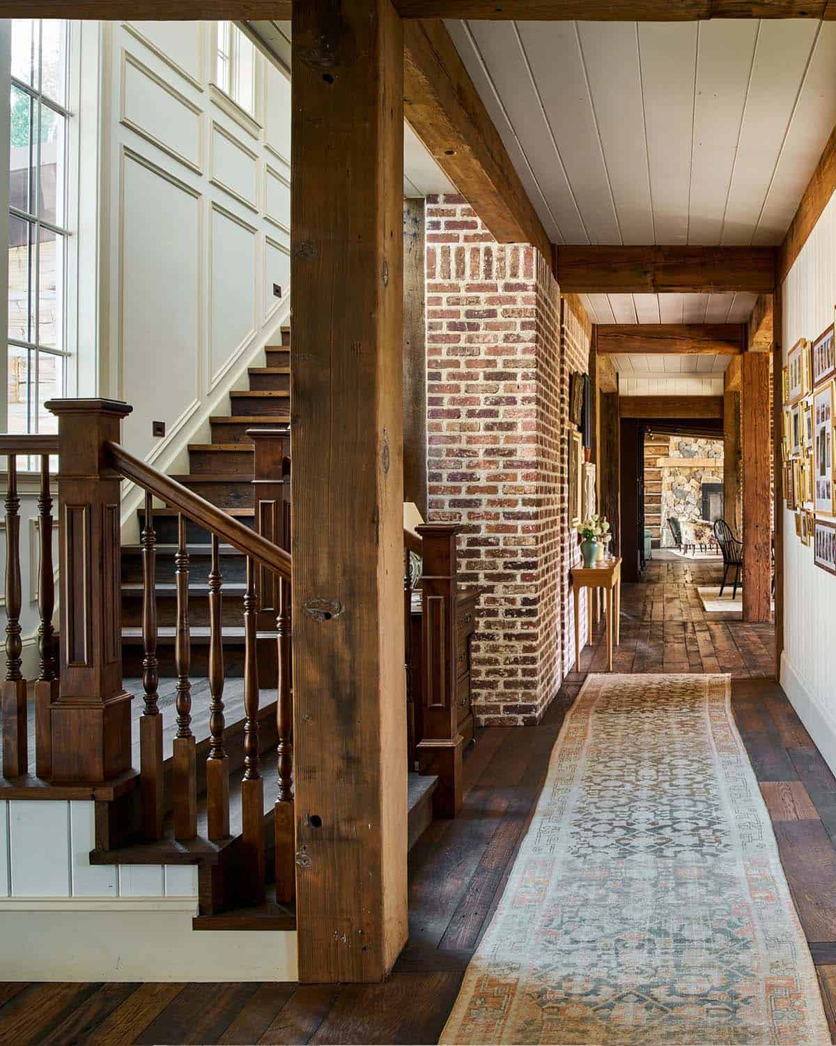 Hallway with exposed brick column and antique runner rug