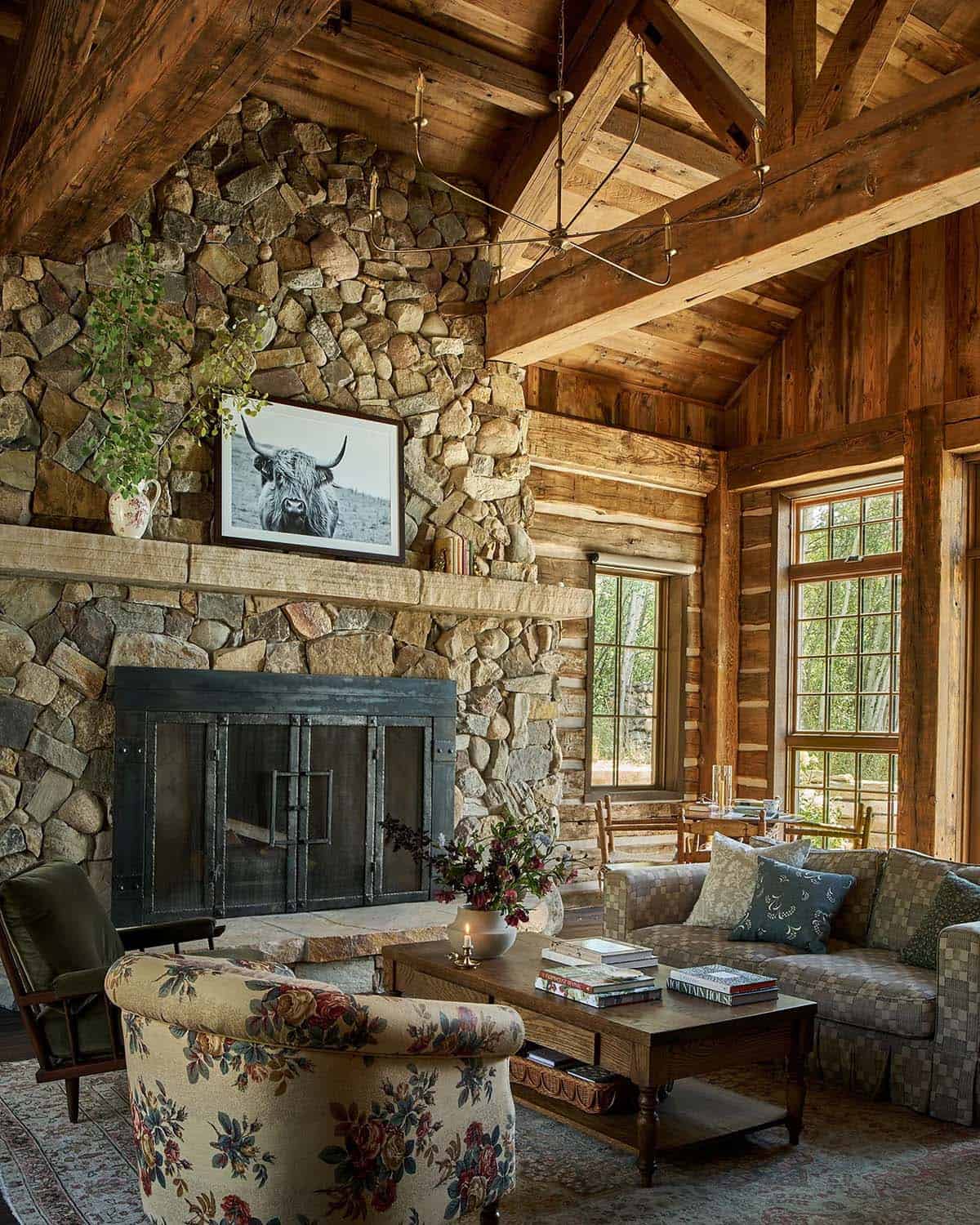 Living room with stacked stone fireplace and floral armchair