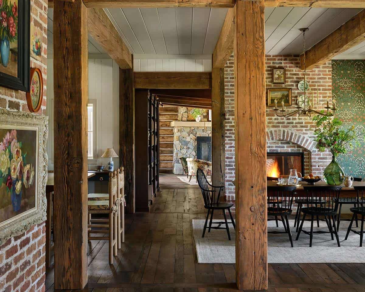 View through reclaimed beams into brick-walled dining room