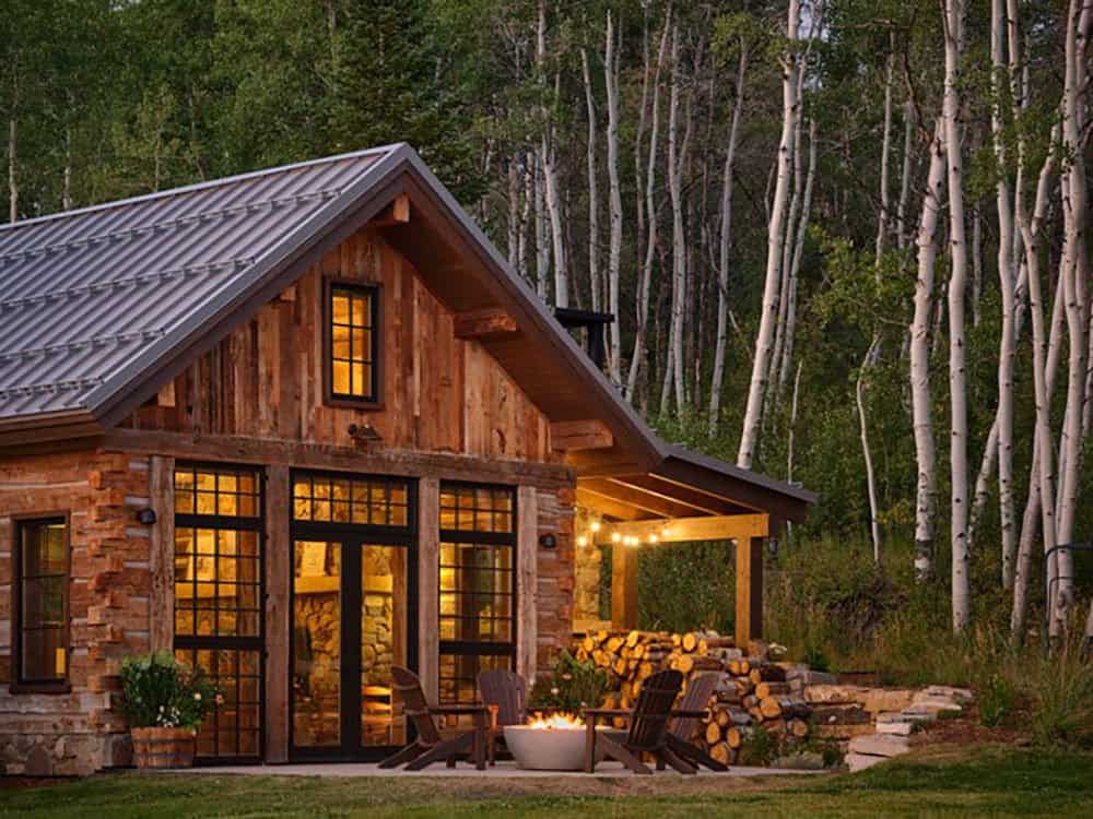 Cabin exterior with fire pit and stacked firewood display