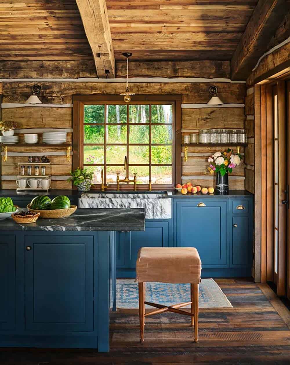 Log cabin kitchen with navy island and soapstone counters