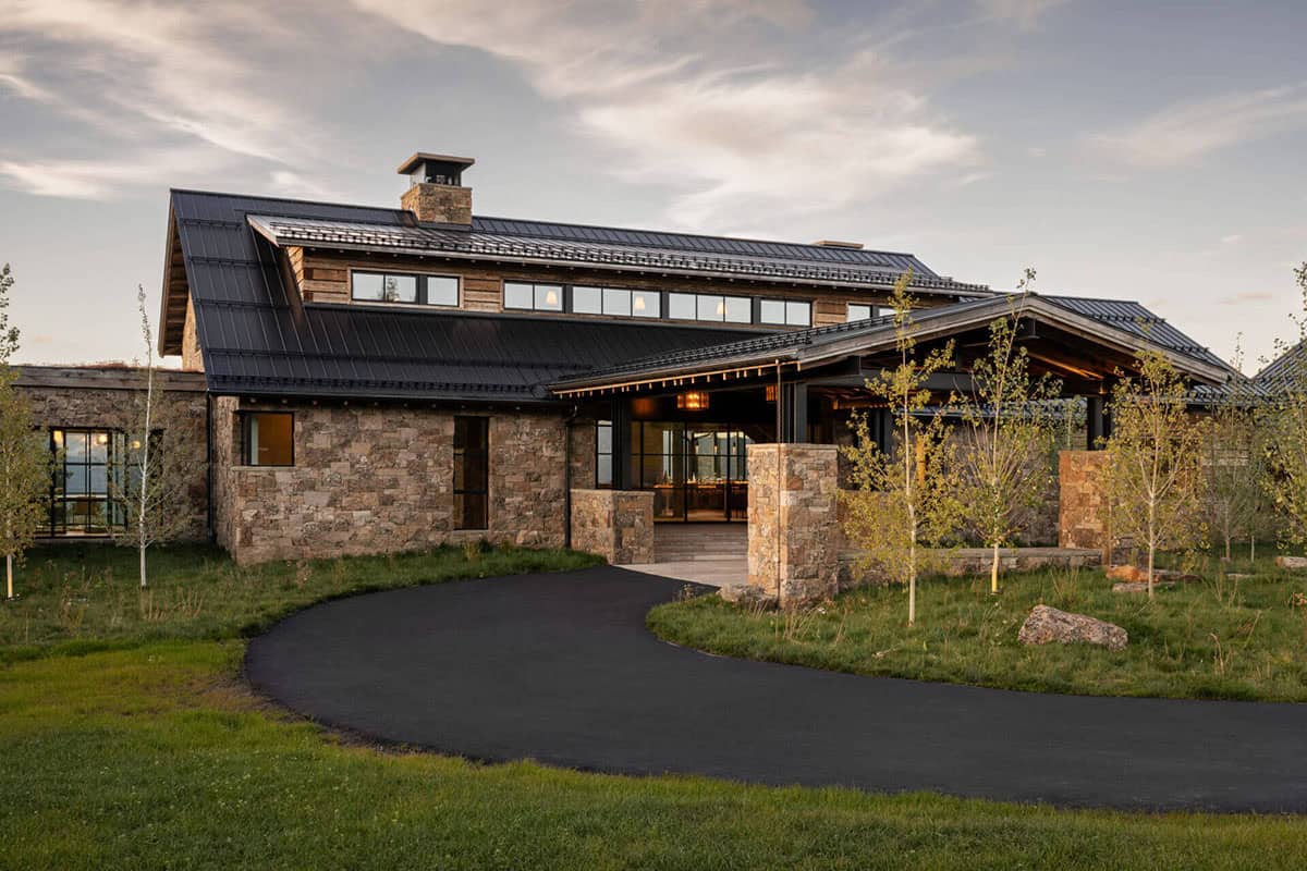 Stone and timber entrance facade of modern rustic ski lodge