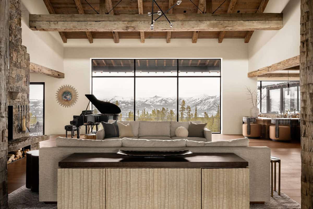 Living room with grand piano and panoramic mountain window