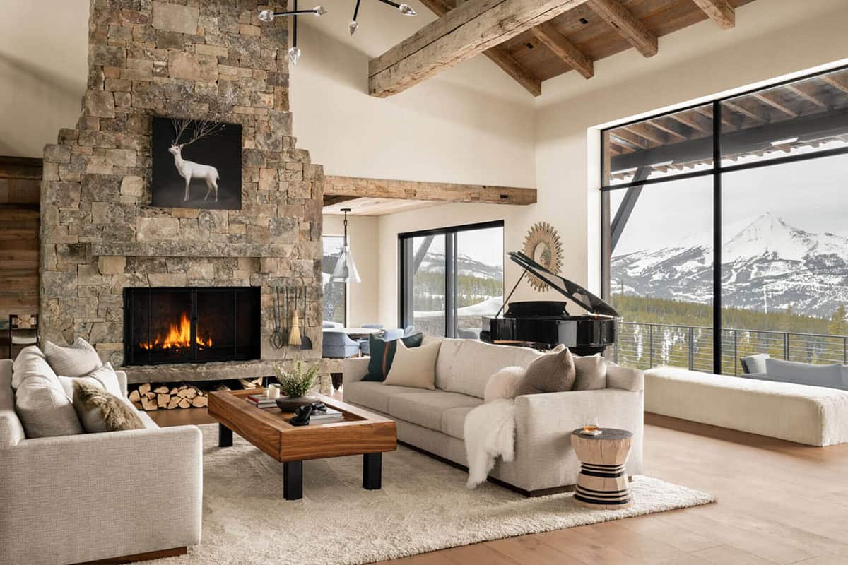 Living room stone fireplace with deer art and mountain view