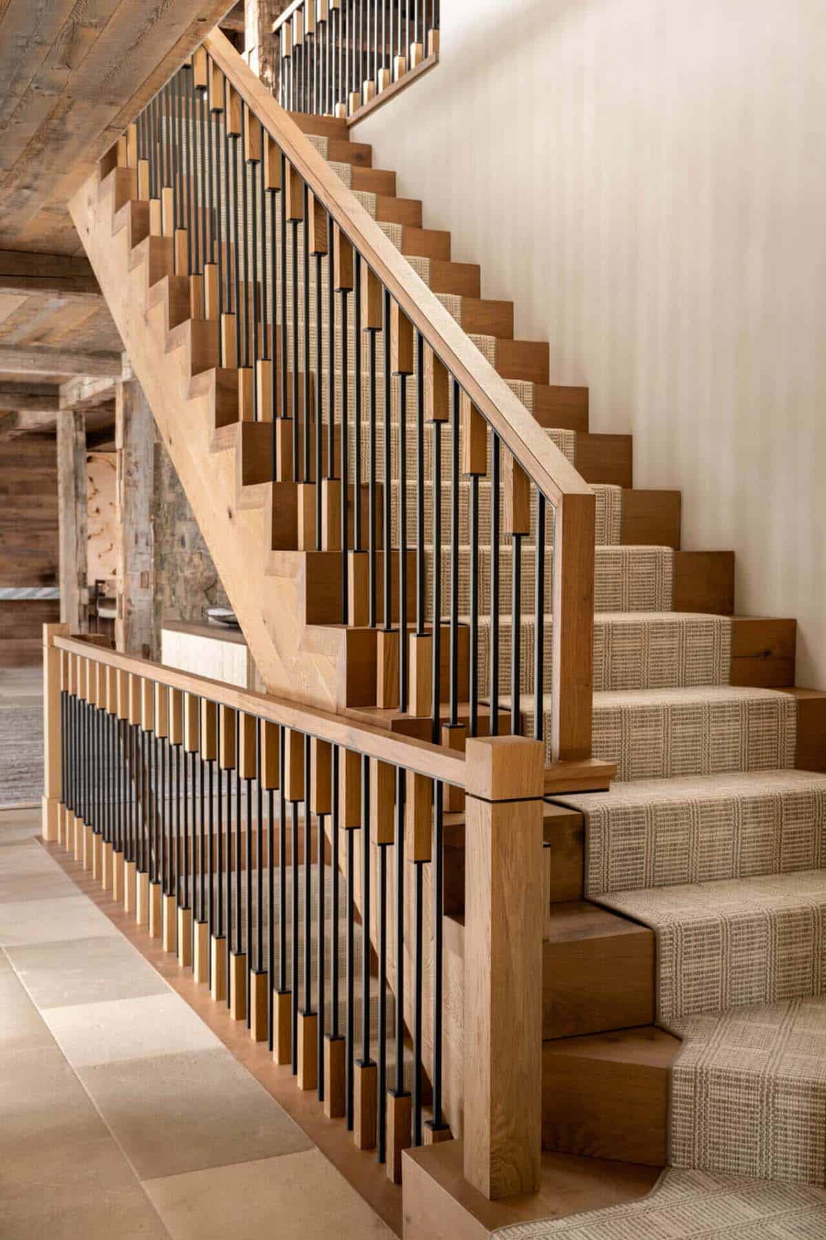 Detail of oak staircase with slim black metal balusters