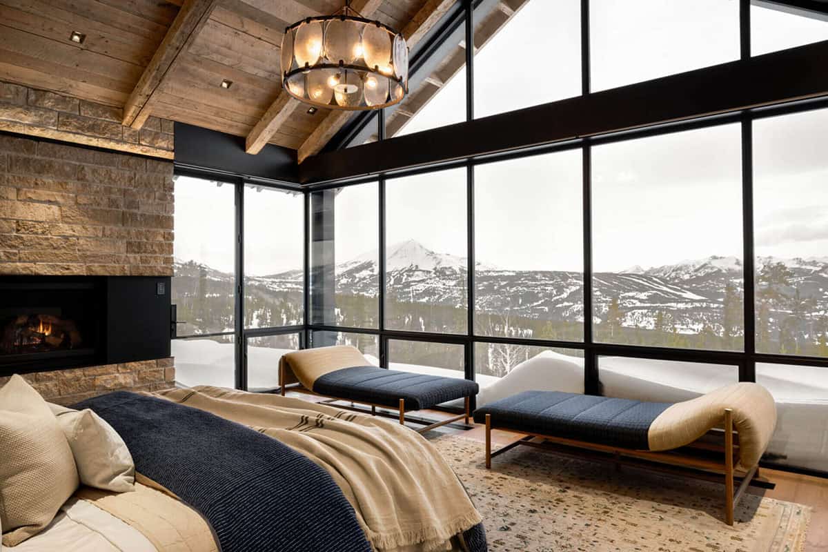Primary bedroom daybeds facing floor-to-ceiling mountain view windows