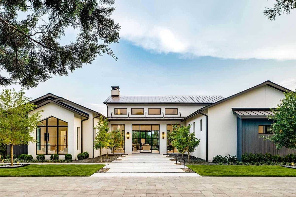Modern transitional home exterior with metal roof and stone pathway