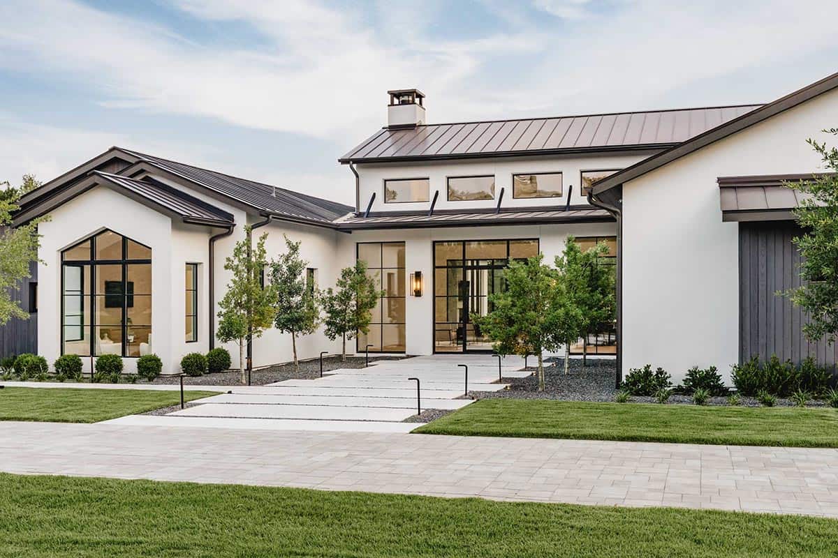 Angled exterior view of gabled roofline and steel-framed glass entry