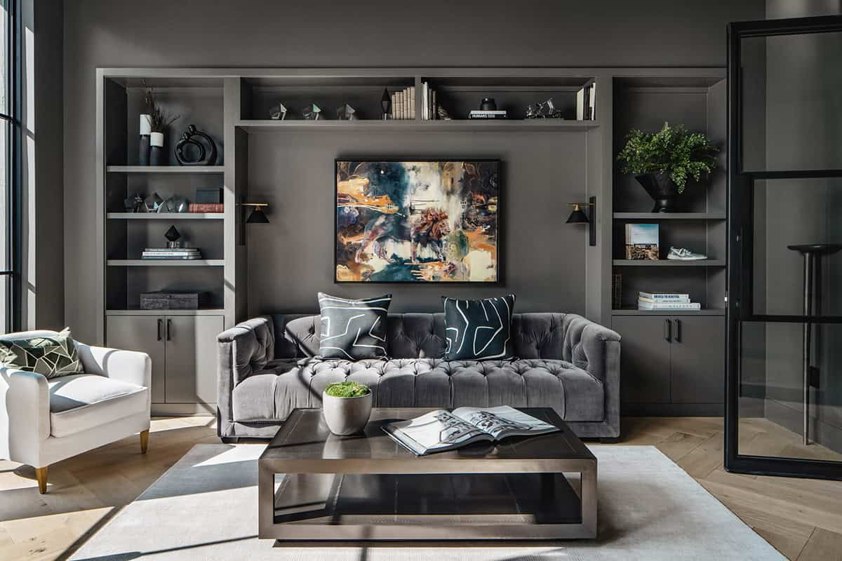 Charcoal living room with tufted sofa and abstract framed artwork