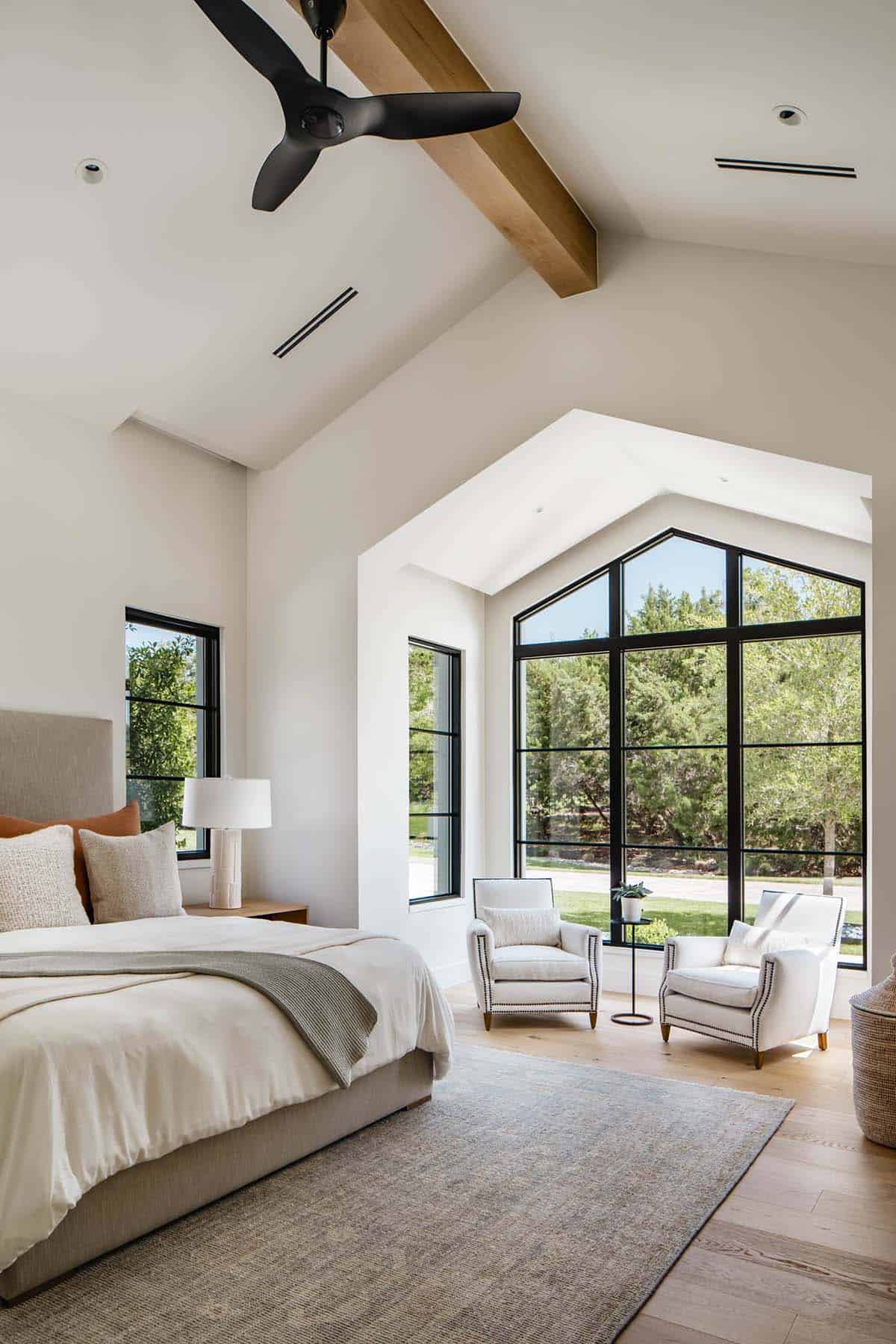 Primary bedroom with vaulted ceiling and gabled steel-framed window nook