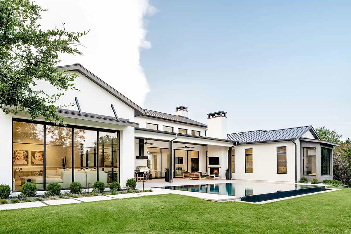 Rear exterior showing pool, covered patio, and standing seam roofline